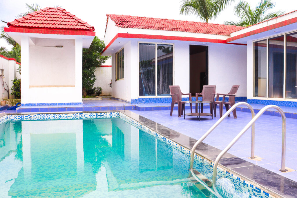 Sihra Villa, Neral: the pool ladder, deck chairs and the villa's glass doors
