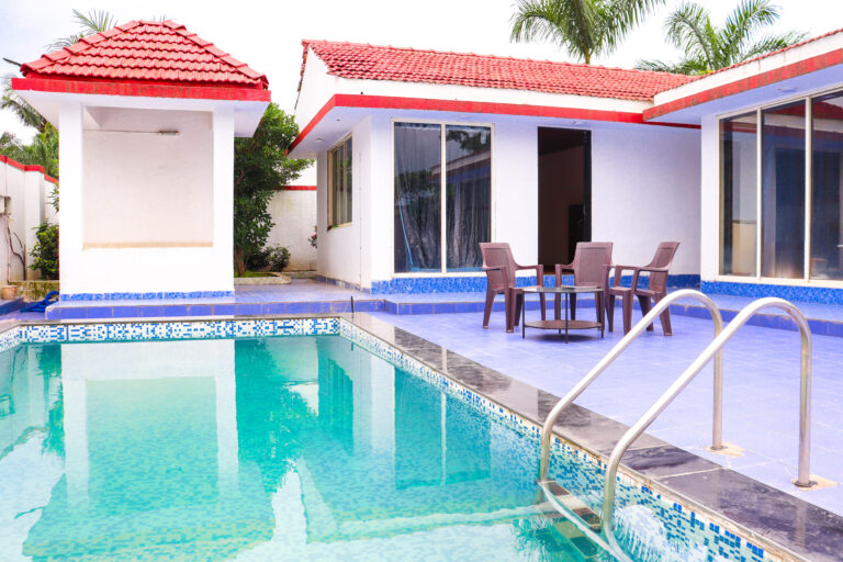 Sihra Villa, Neral: Pool ladder and outdoor seating by the glass doors